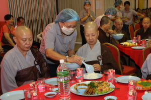 义工给北传法师盛饭